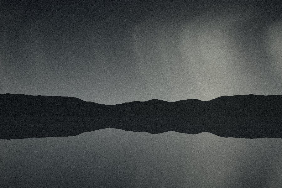 Dark headland mirrored in grey water under falling rain