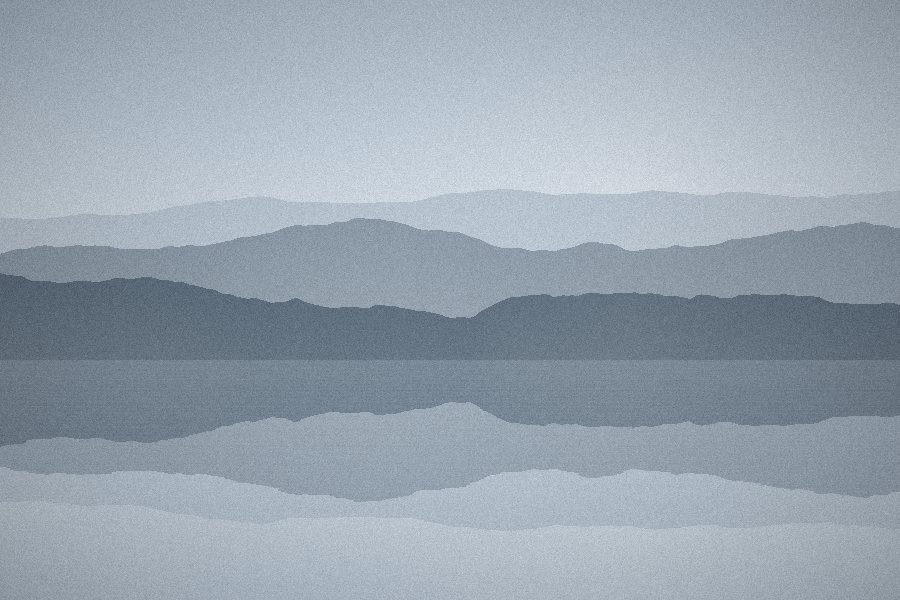 Pale blue hills reflected in a calm winter lake
